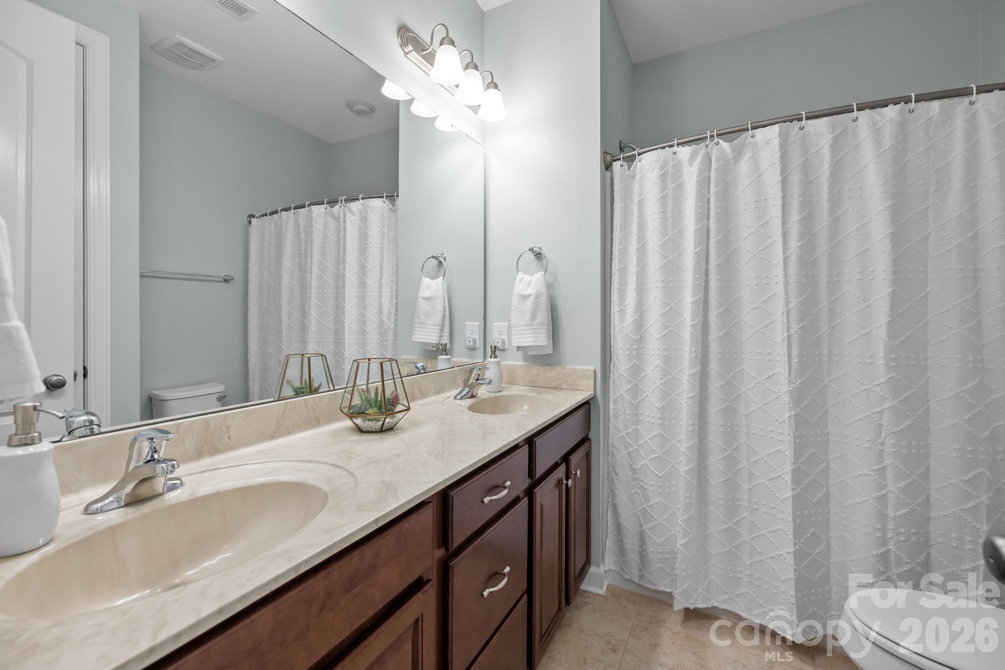 2072 Clarion Drive Fort Mill, SC 29707 - Photo 33 of 47 a bathroom with a double vanity sink and a mirror