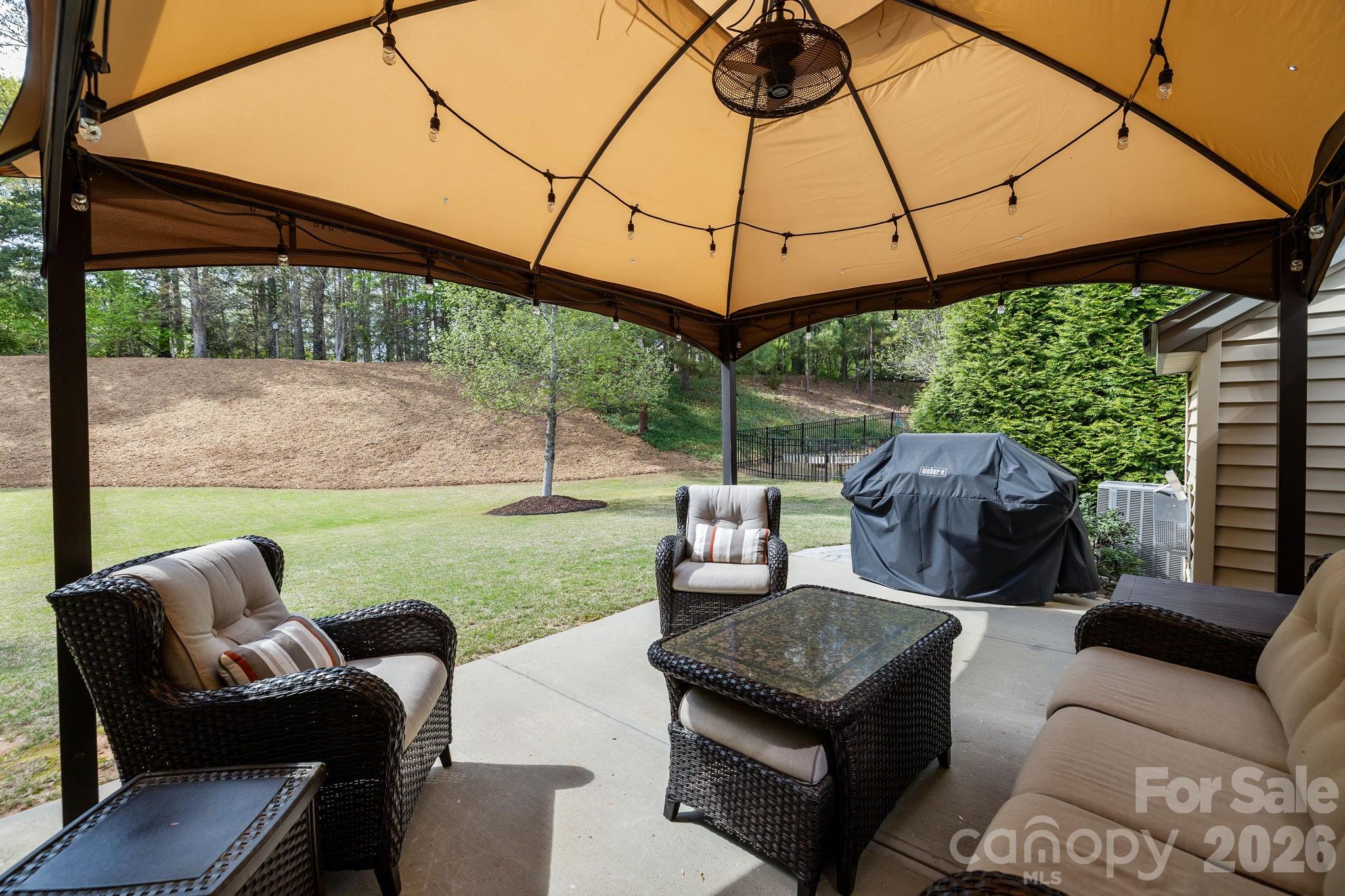 2072 Clarion Drive Fort Mill, SC 29707 - Photo 40 of 47 a view of a patio with couches chairs under an umbrella