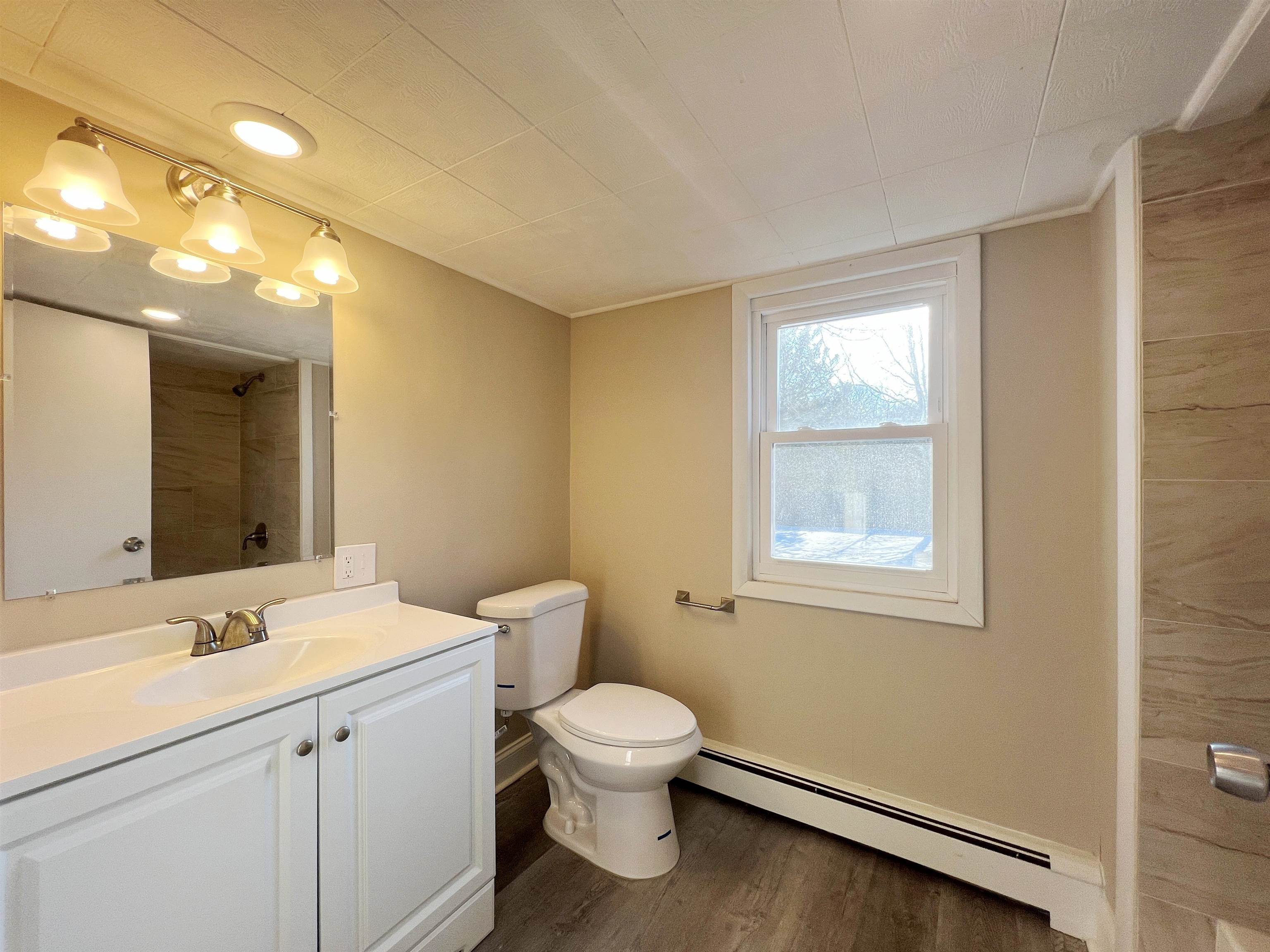 1340 Highway 9 Palermo, NJ 08230 - Photo 31 of 32 a bathroom with a toilet sink a mirror and vanity
