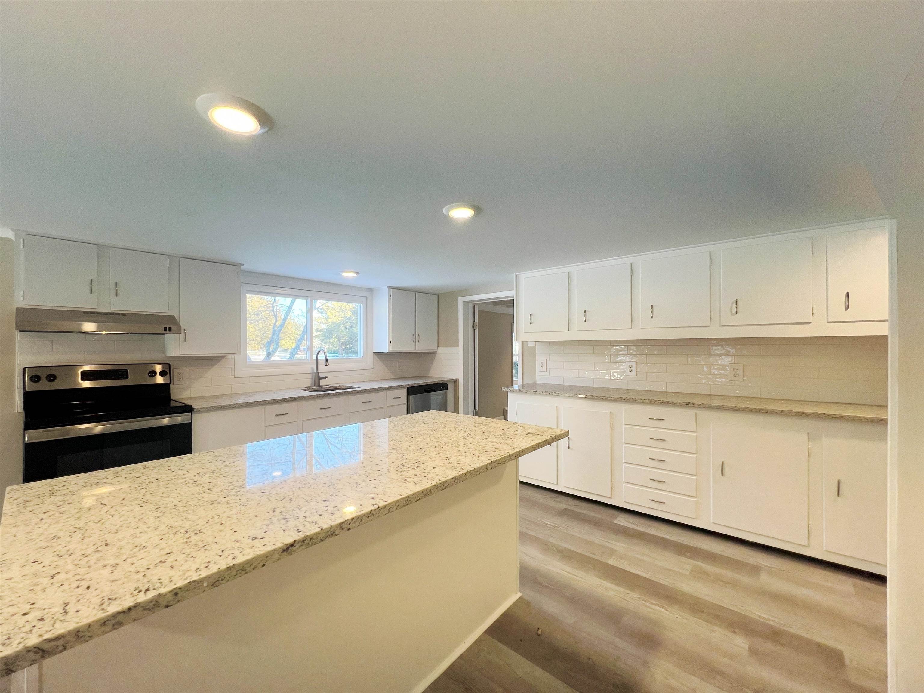 1340 Highway 9 Palermo, NJ 08230 - Photo 9 of 32 a large kitchen with granite countertop a sink white cabinets and stainless steel appliances