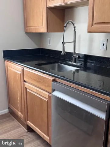 a close view of sink a faucet and light in the kitchen