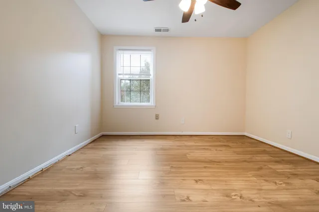 a view of a bathroom with a shower and wooden floor