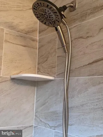 a white bath tub sitting next to a toilet