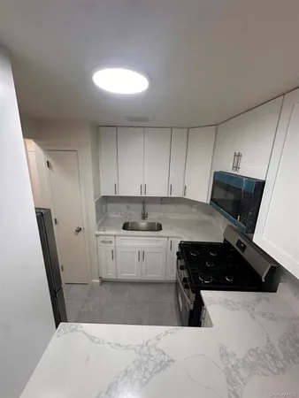 a kitchen with a sink and cabinets