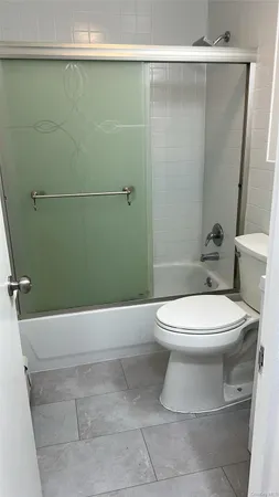 a bathroom with a toilet and shower