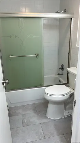 a bathroom with a toilet and shower