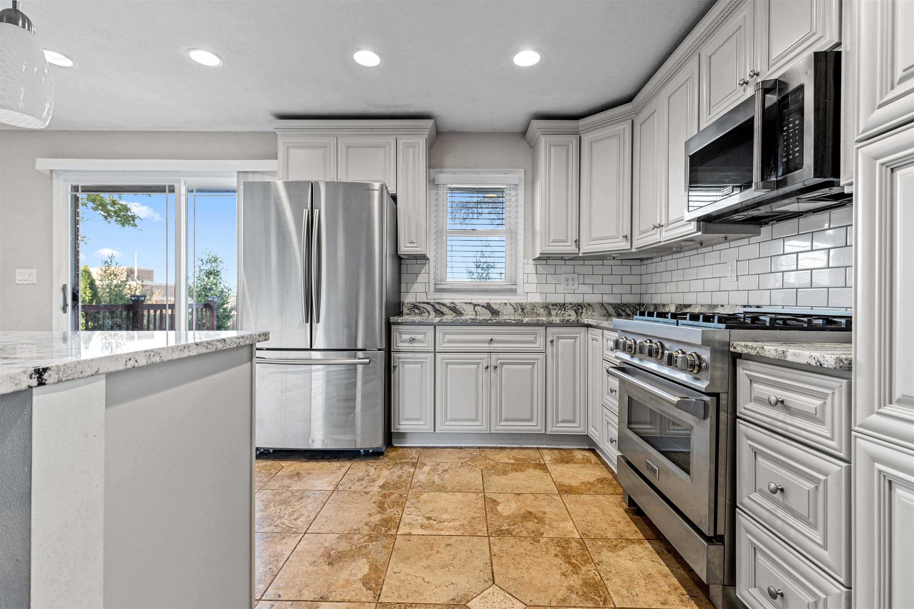 7056 Sentinel Road Rockford, IL 61107 - Photo 3 of 25 a kitchen with stainless steel appliances granite countertop a refrigerator sink and stove