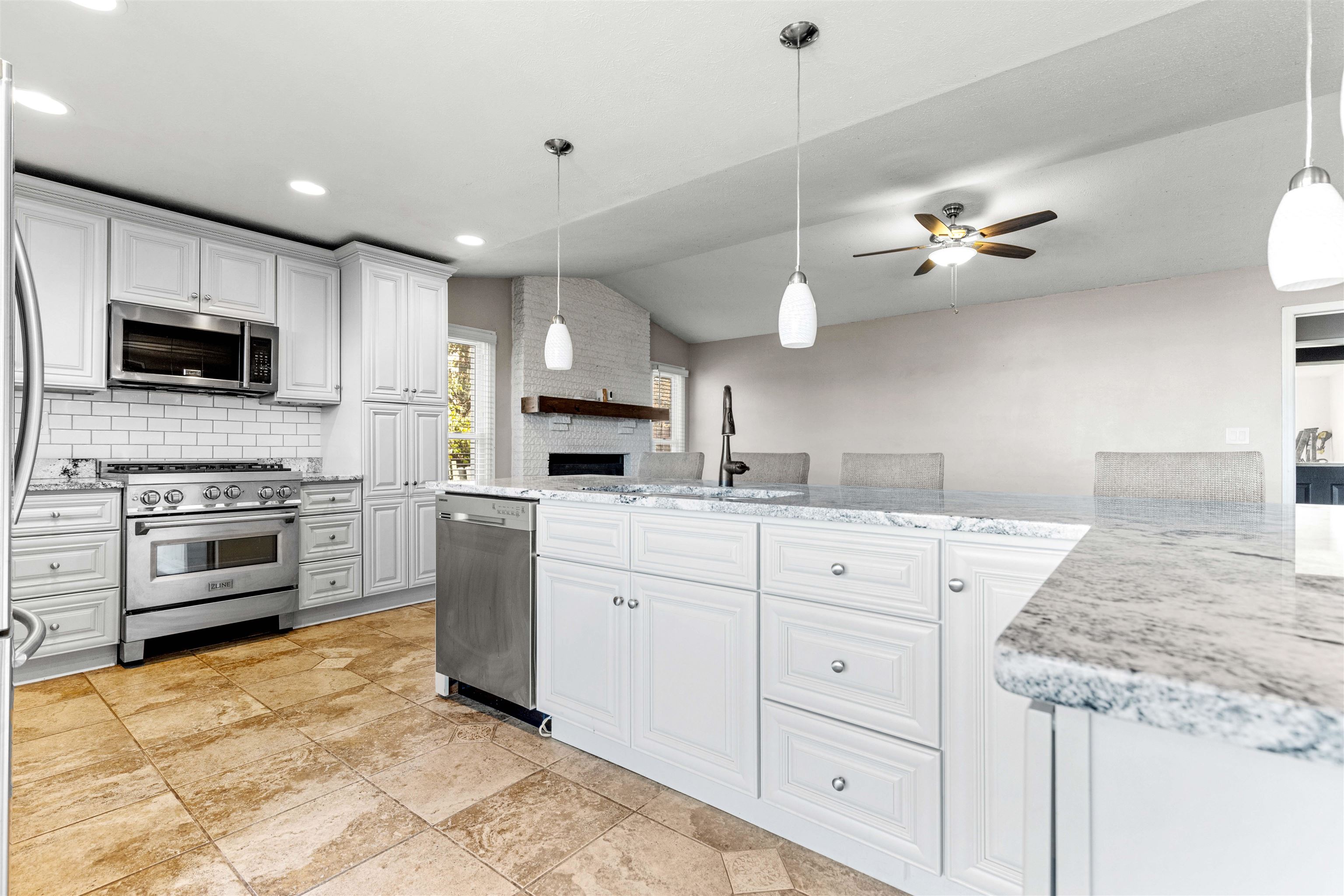 7056 Sentinel Road Rockford, IL 61107 - Photo 4 of 25 a kitchen with a stove a microwave and a refrigerator