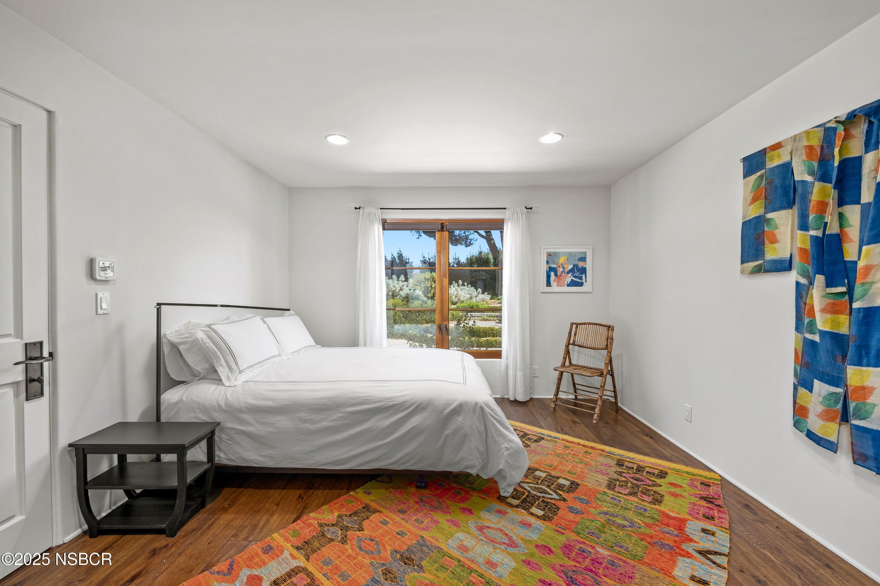 3001 Long Valley Road Santa Ynez, CA 93460 - Photo 26 of 52 a bedroom with a bed and wooden floor
