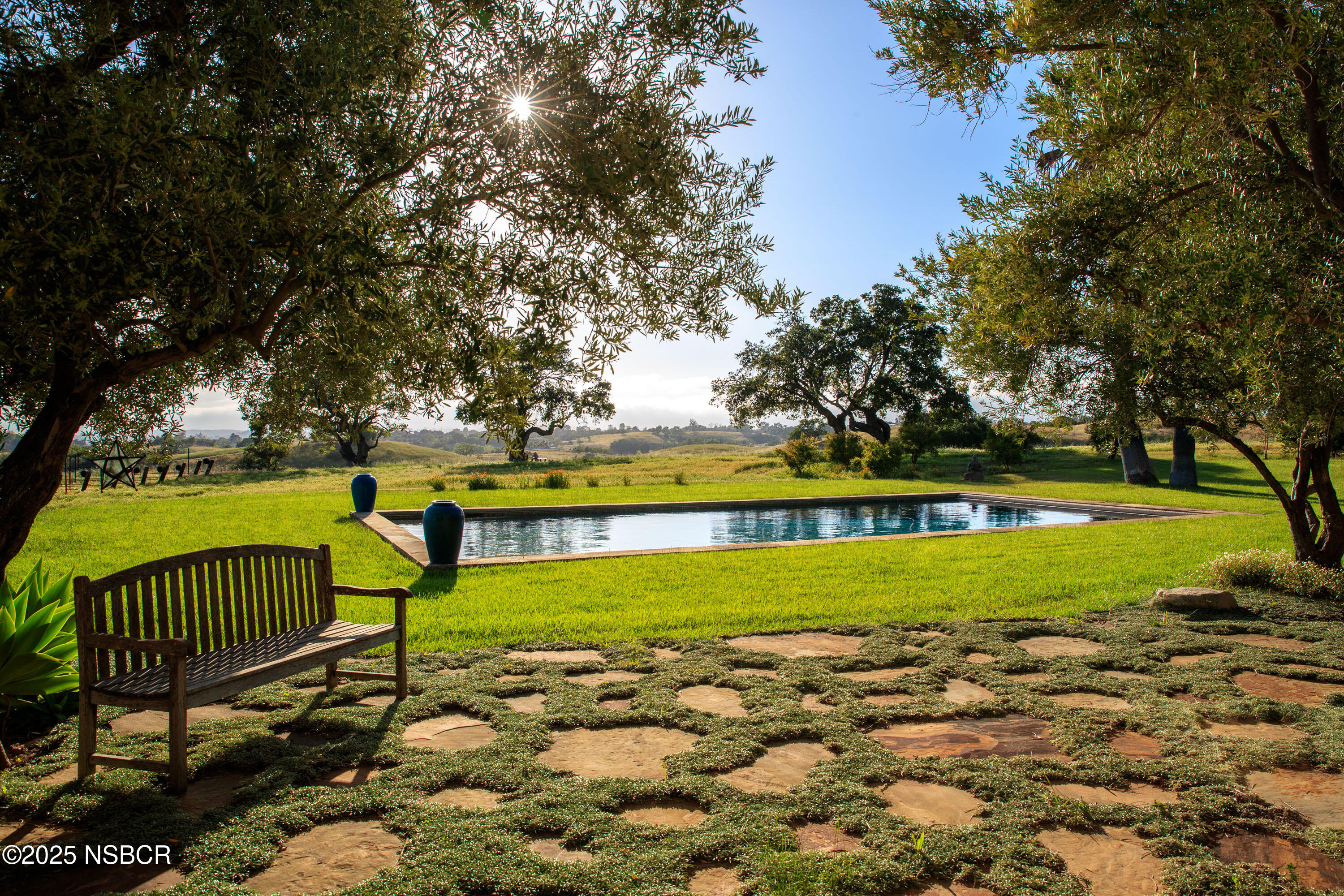 3001 Long Valley Road Santa Ynez, CA 93460 - Photo 7 of 52 a view of a swimming pool with a bench and trees around
