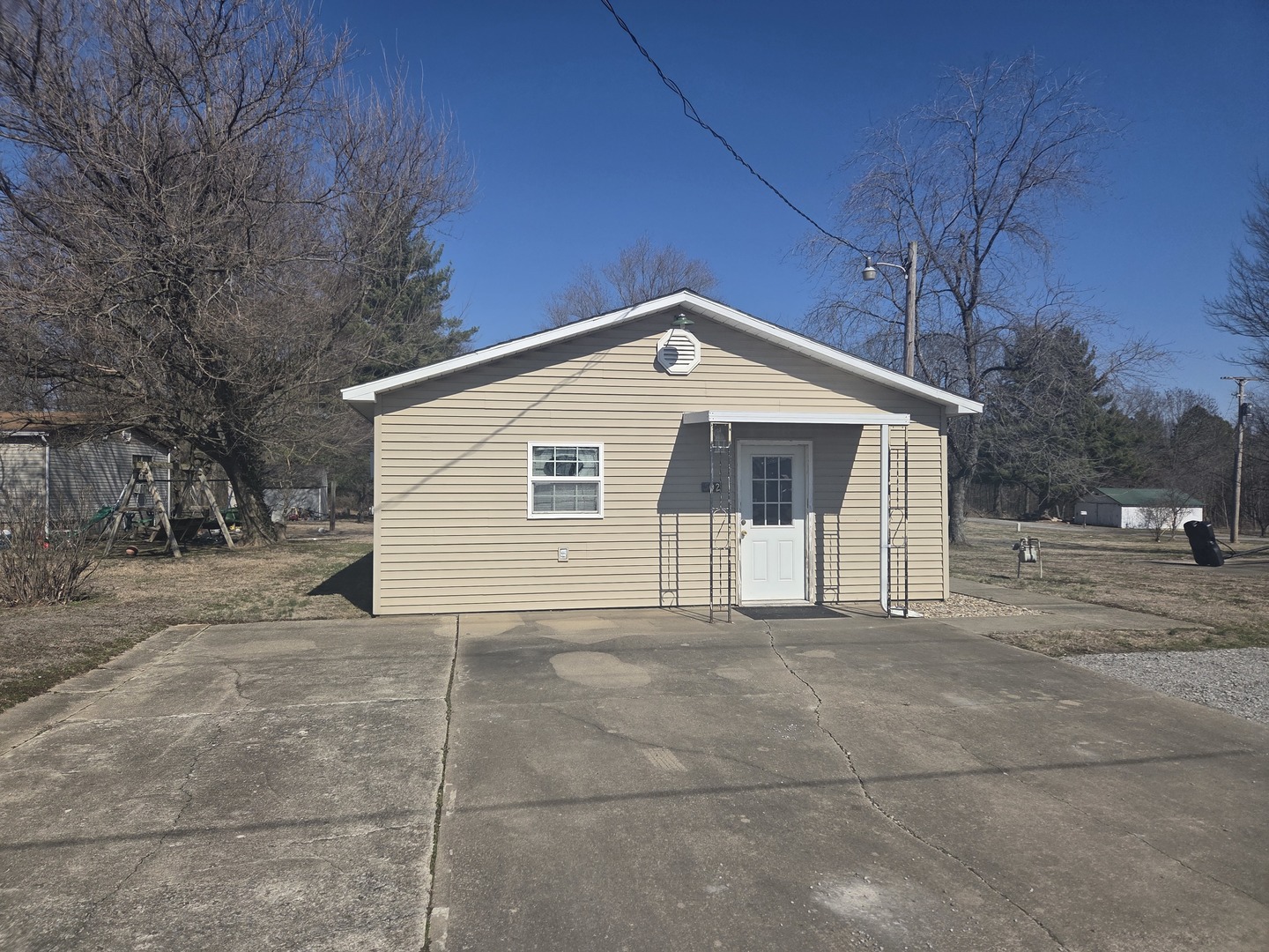 a view of house with a yard and garage