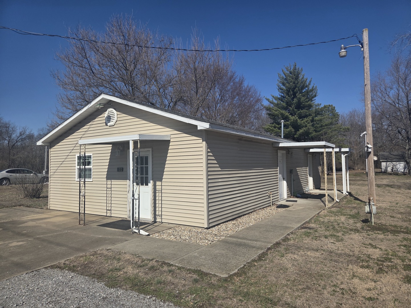 502 Old Brickyard Road McLeansboro, IL 62859 - Photo 3 of 16 a front view of a house with a yard and garage
