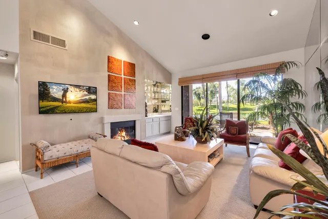 a living room with furniture fireplace and a fireplace