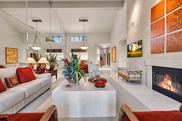 a living room with furniture a fireplace and next to a window