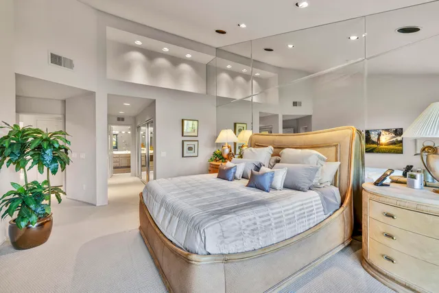 a bedroom with a bed and a potted plant