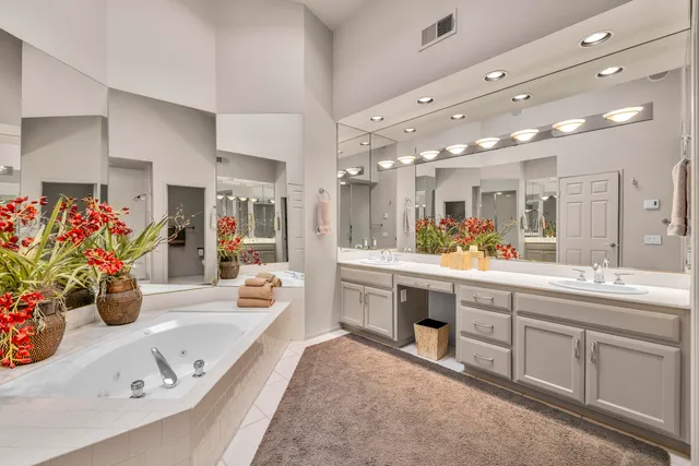 a spacious bathroom with a shower and a sink