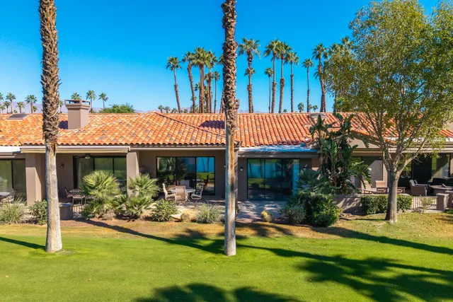 a view of a chairs and table in patio