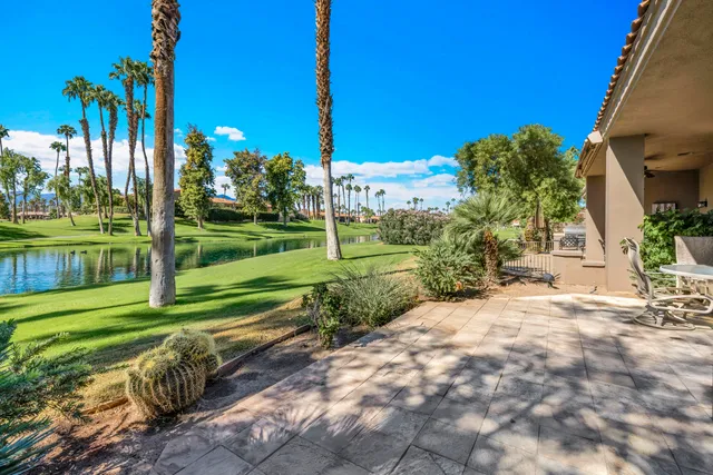 a view of an ocean with boats and palm trees