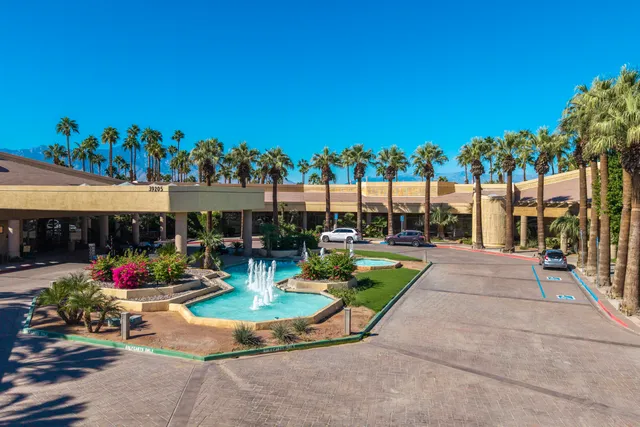 an aerial view of multi story residential apartment building with a yard