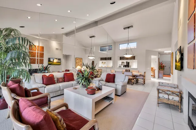a living room with furniture kitchen and a chandelier