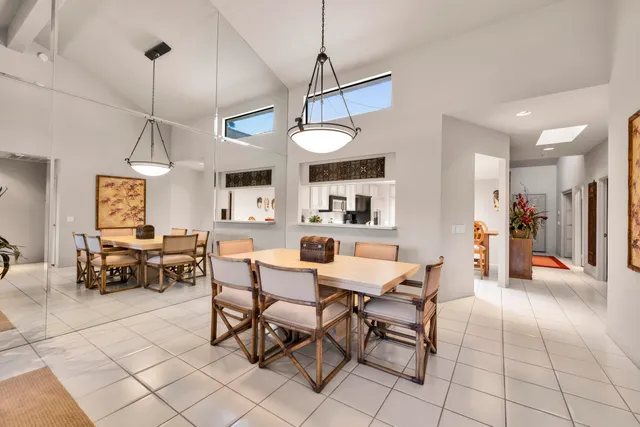 a view of a dining room with furniture and chandelier