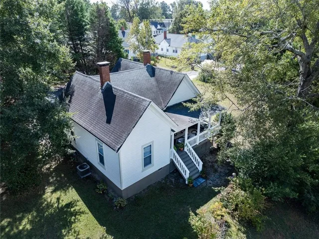 a aerial view of a house with a yard basket ball court and outdoor seating