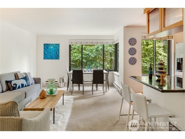 1105 Spring Street, Unit 305 Seattle, WA 98104 - Photo 14 of 25 a living room with furniture and a large window