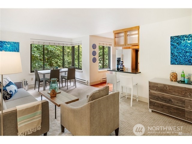 1105 Spring Street, Unit 305 Seattle, WA 98104 - Photo 15 of 25 a living room with furniture and a large window