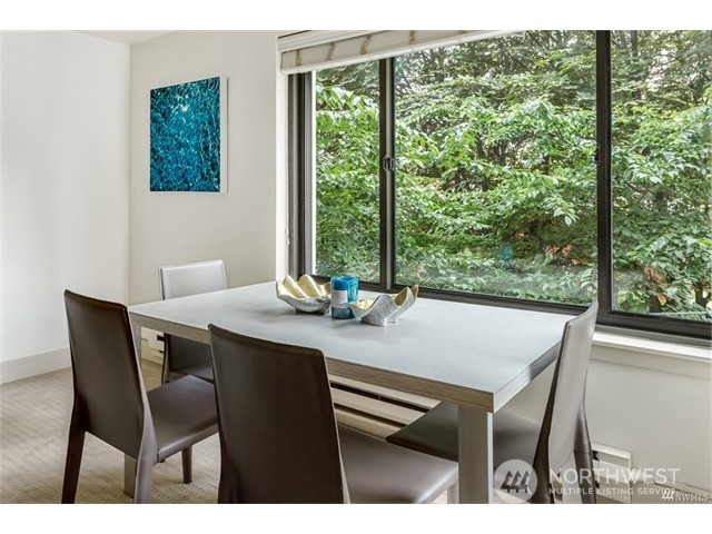 1105 Spring Street, Unit 305 Seattle, WA 98104 - Photo 16 of 25 a view of a dining room with furniture window and outside view