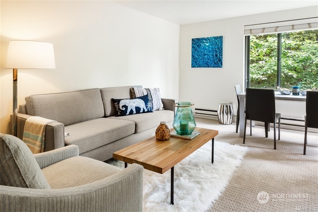 1105 Spring Street, Unit 305 Seattle, WA 98104 - Photo 2 of 25 a living room with furniture and a large window
