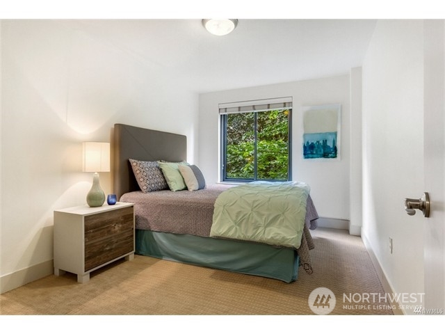 1105 Spring Street, Unit 305 Seattle, WA 98104 - Photo 25 of 25 a bed sitting in a bedroom next to a window