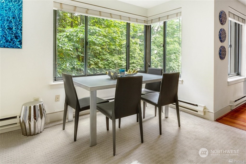 1105 Spring Street, Unit 305 Seattle, WA 98104 - Photo 4 of 25 a view of a dining room with furniture window and outside view