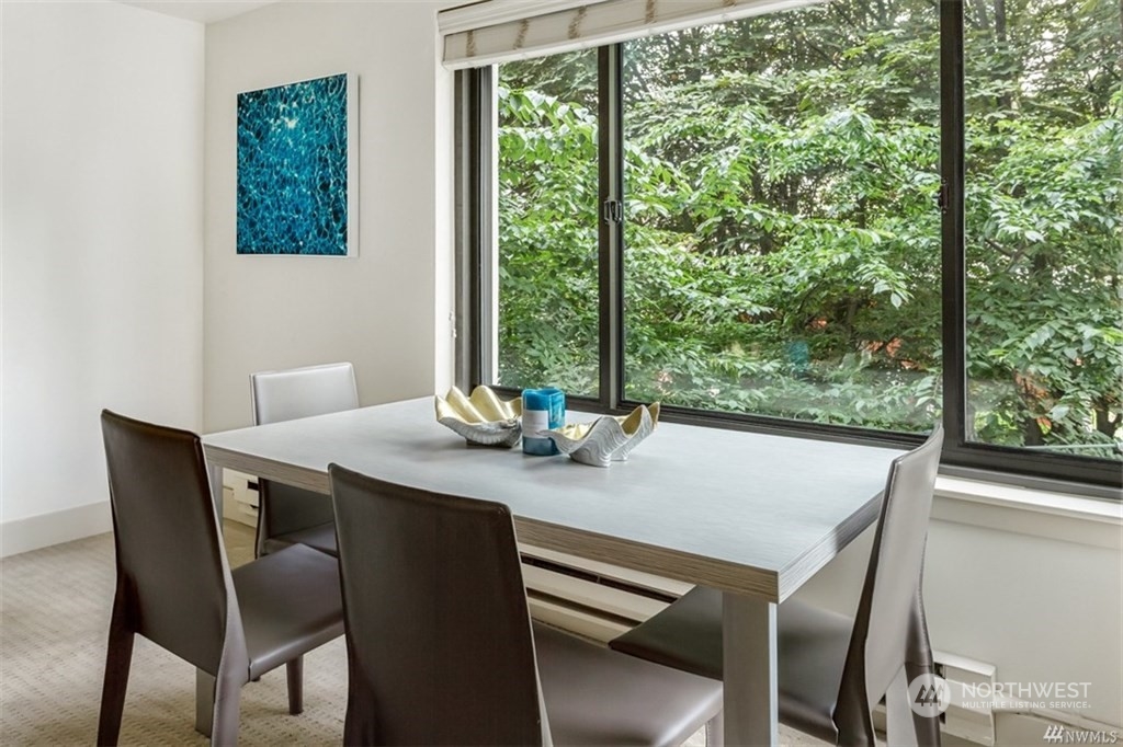 1105 Spring Street, Unit 305 Seattle, WA 98104 - Photo 6 of 25 a view of a dining room with furniture window and outside view