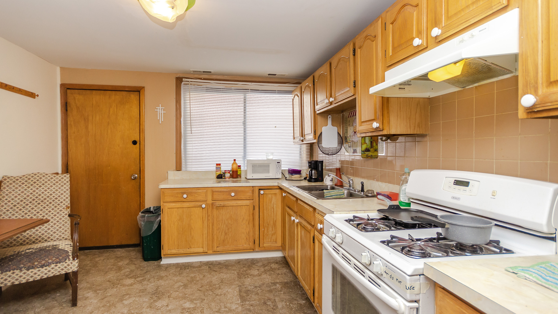 3323 North Pulaski Road Chicago, IL 60641 - Photo 2 of 12 a kitchen with a sink stove and cabinets