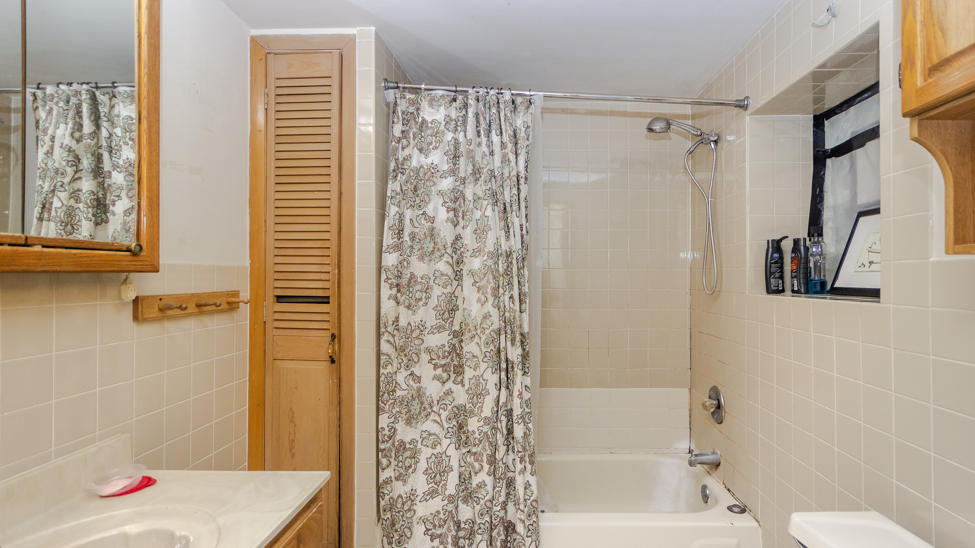 3323 North Pulaski Road Chicago, IL 60641 - Photo 5 of 12 a bathroom with a shower curtain a toilet and a shower