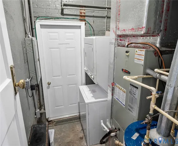 a utility room with dryer washer and stair