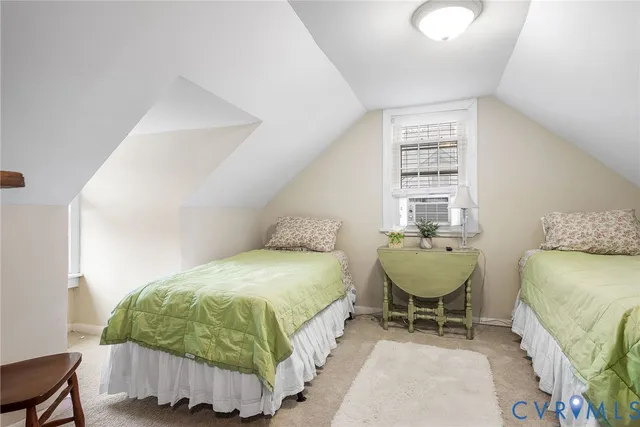 a bedroom with a bed chair and window