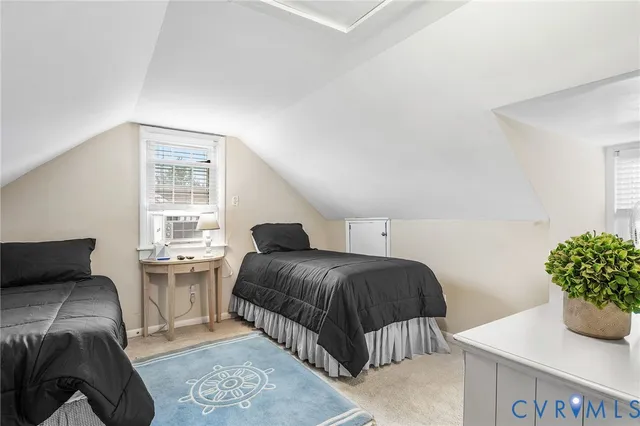 a bedroom with a bed and a potted plant