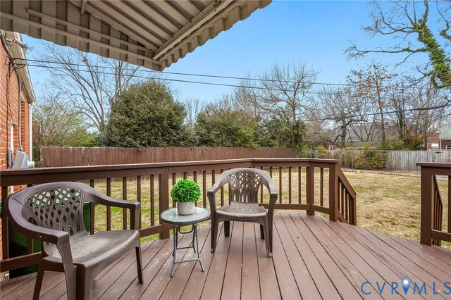 a view of balcony with wooden floor and outdoor seating