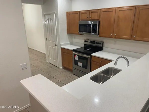 a kitchen with stainless steel appliances a stove microwave and sink