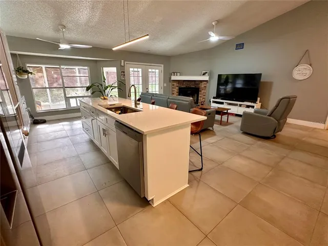a large white kitchen with a large window