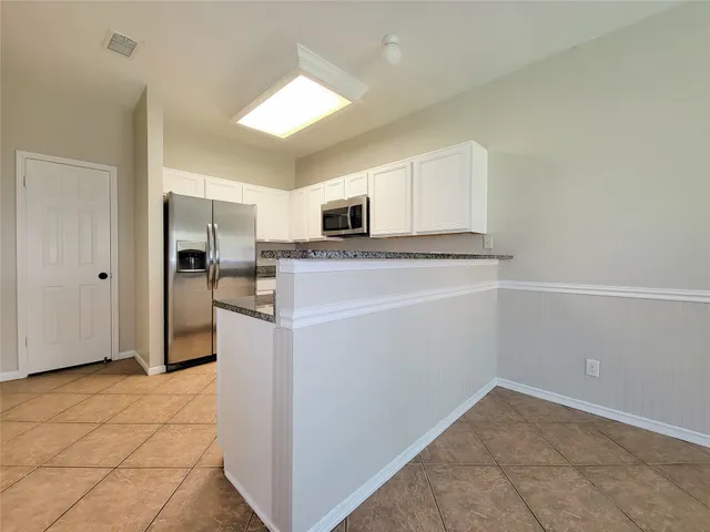 a kitchen with a refrigerator sink and microwave