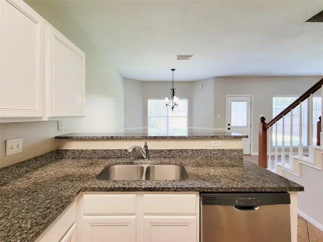 a kitchen with granite countertop a sink and a granite counter tops