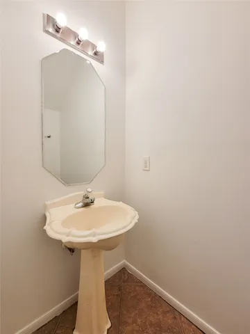 a bathroom with a sink a mirror and toilet