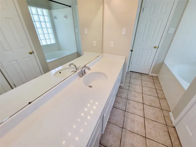 a bathroom with a sink a toilet a mirror and window