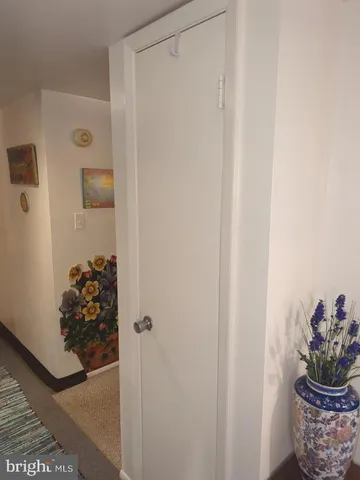 a view of a closet with wooden floor and shoes