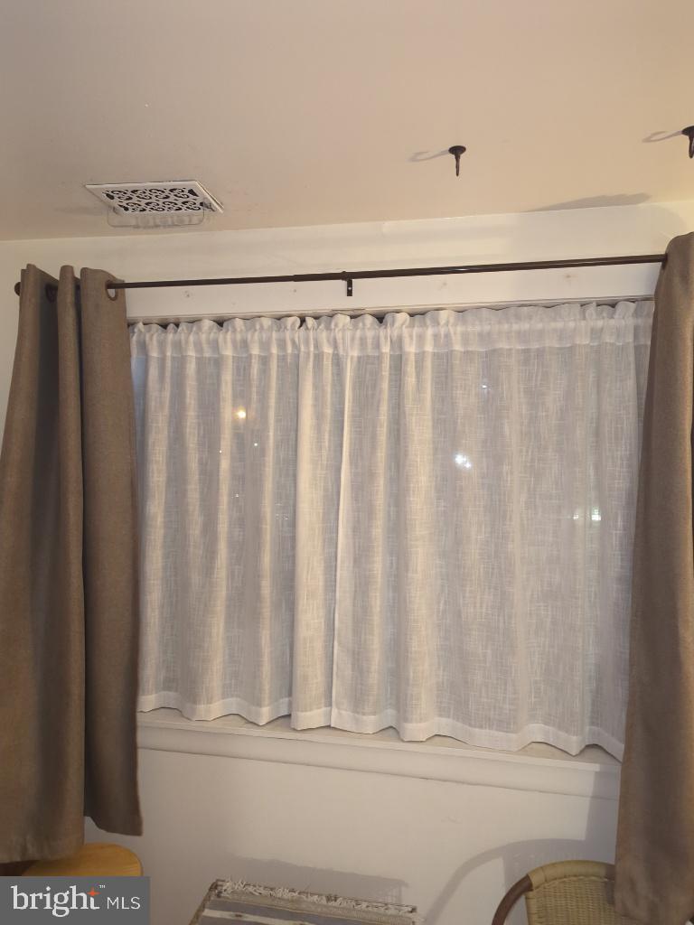 6065 Majors Lane, Unit 1 Columbia, MD 21045 - Photo 12 of 25 a view of wooden floor with a curtain