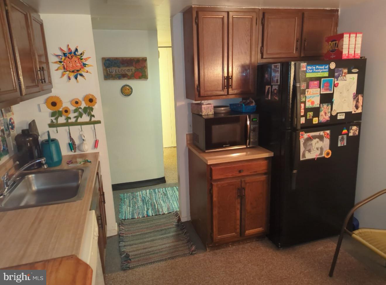 6065 Majors Lane, Unit 1 Columbia, MD 21045 - Photo 4 of 25 a kitchen with stainless steel appliances granite countertop a refrigerator and a sink