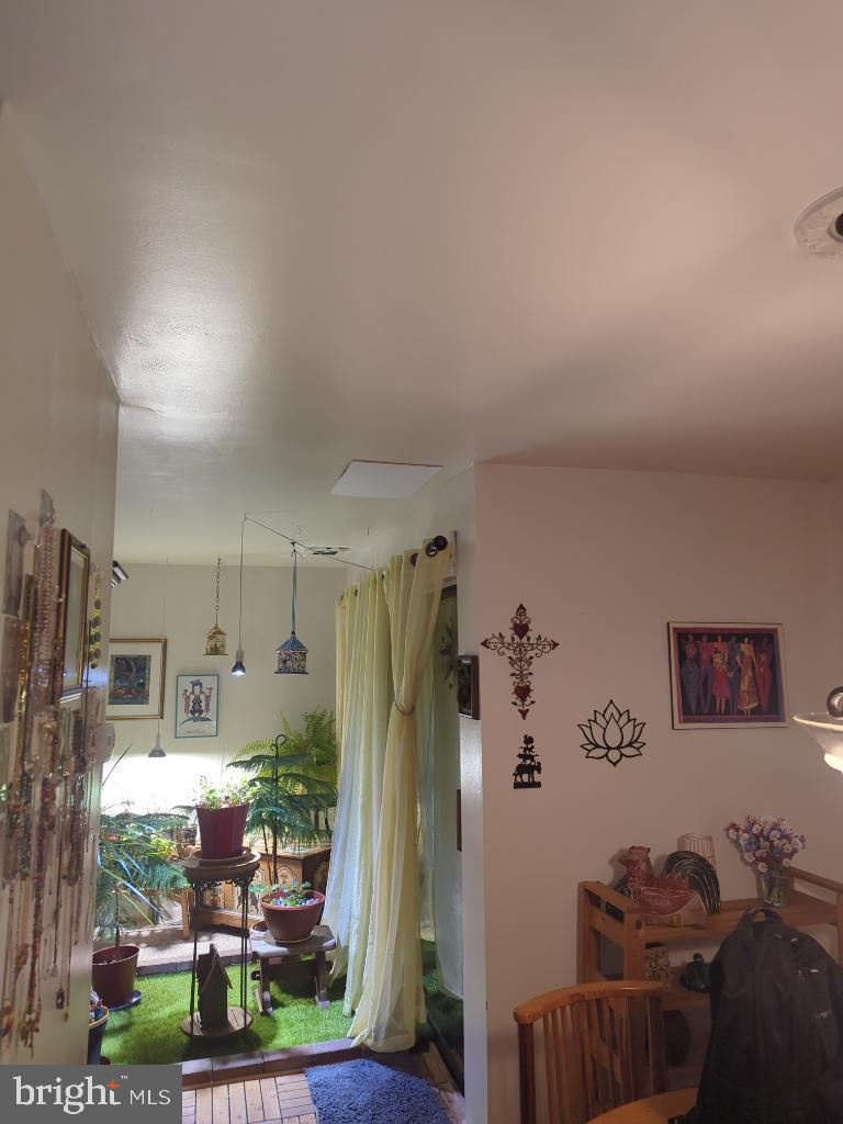 6065 Majors Lane, Unit 1 Columbia, MD 21045 - Photo 10 of 25 a kitchen with stainless steel appliances granite countertop a refrigerator and a view of living room