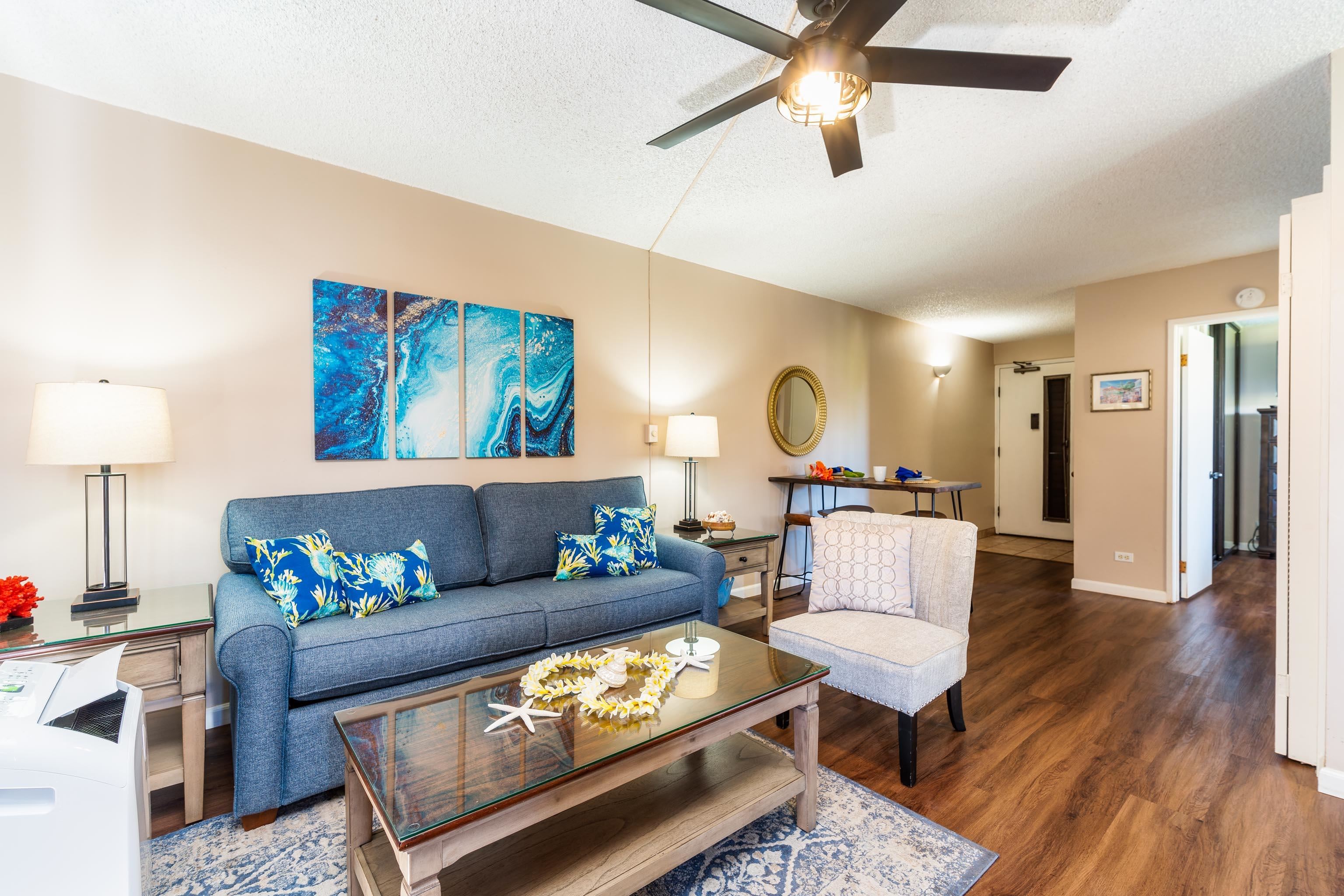 4310 Lower Honoapiilani Road, Unit 418 Lahaina, HI 96761 - Photo 12 of 31 a living room with furniture and a wooden floor